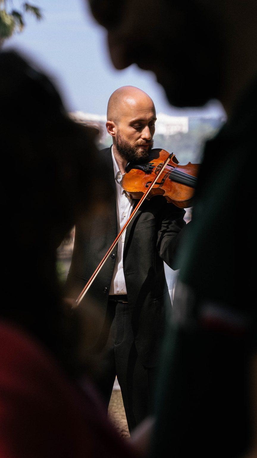 Talented violinist playing a romantic serenade during a marriage proposal.